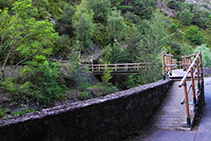 Puente de madera que cruza el río.